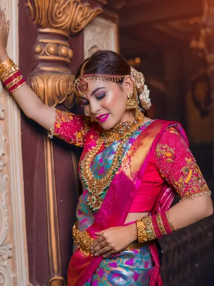A stunning combination of a multi-colored saree and heavy temple jewellery. The makeup is bold to match the grand look.