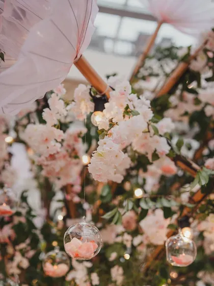 A close-up of the delicate floral details, with hanging glass baubles and soft lighting. These small touches add a layer of magic and whimsy to the decor.