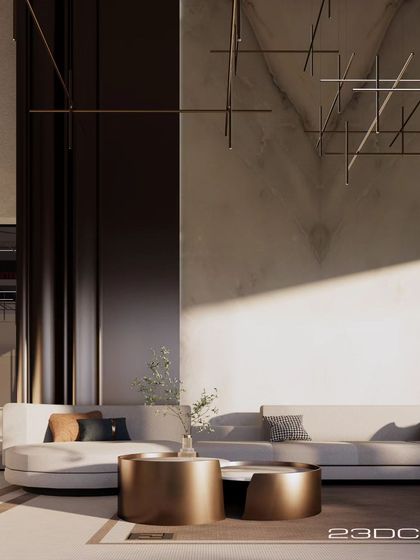 Sunlight grazes a textured wall in the Meraki living room, highlighting the interplay of light and shadow. The minimalist sofa and metallic coffee tables add a touch of understated, contemporary chic.