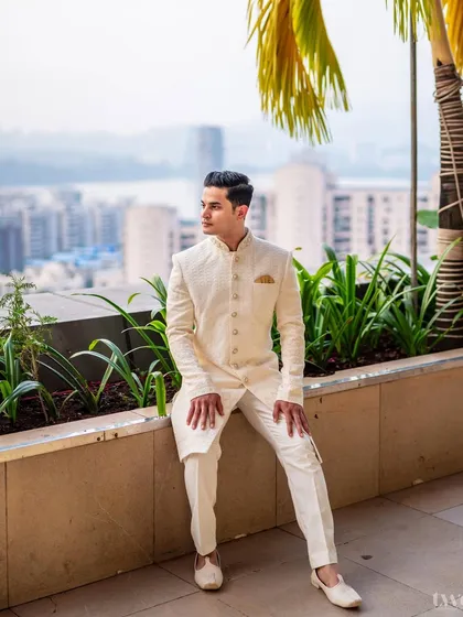 The groom Akshat, looking sharp and elegant against the city skyline before the wedding ceremony.