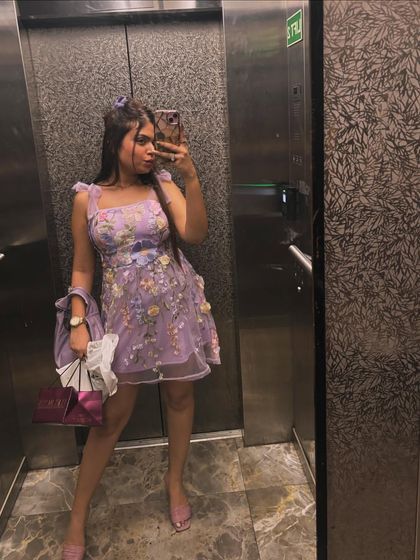 An elevator selfie showing off my full birthday look, from the dress to the matching accessories.