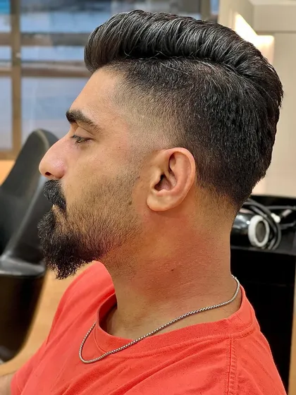 A side profile of the classic fade, showcasing the clean taper and voluminous top.