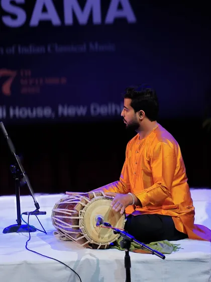 Deep in concentration during a Pakhavaj recital, feeling every beat and vibration.