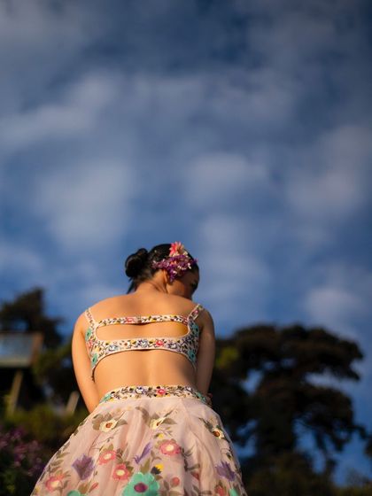 A view from behind, with the model looking out at the sky. This shot creates a sense of freedom and connection with the vastness of nature.