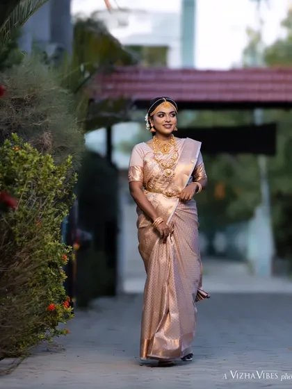 A full-length shot of a model showcasing a traditional muhurtham look, walking gracefully.