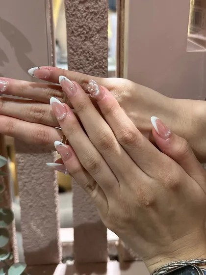 An elegant French manicure on long extensions, made even more special with the addition of a delicate 3D flower.