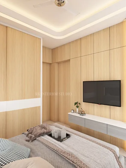 Another view of the small bedroom concept, showing the wardrobe and TV wall. The seamless, handleless wardrobe doors contribute to the clean, minimalist aesthetic.