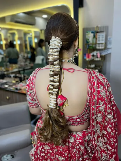 A detailed view of a bridal braid, intricately woven with pearl accessories. This hairstyle is a work of art and perfect for a bride who wants a unique and traditional look.