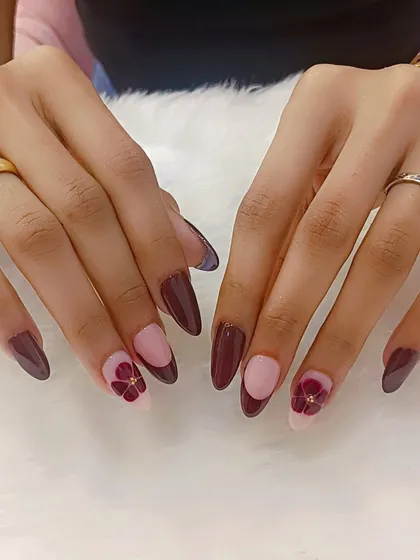 Nails as rich as the wine we’re celebrating with. This beautiful set features deep wine-colored nails with a half-moon design and delicate floral accents.