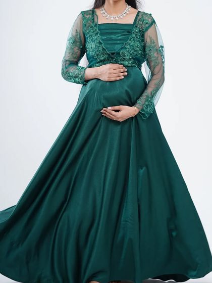 This elegant dark green satin gown comes with a delicate embroidered jacket. It's a sophisticated and comfortable option for both pre-wedding and maternity photoshoots.