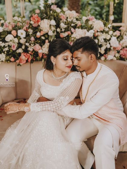 An intimate and romantic portrait of the couple on a sofa at their engagement.