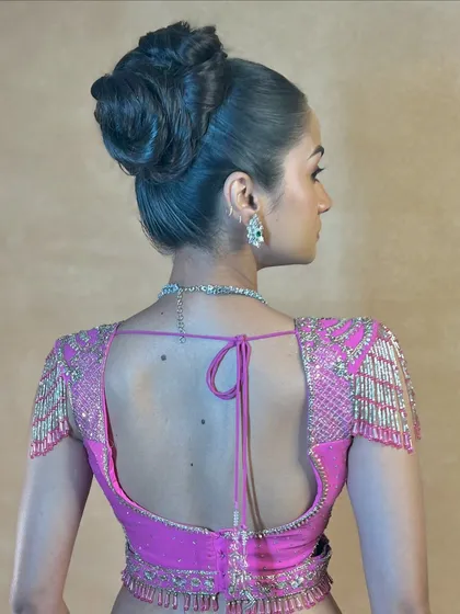 A back view of the high fashion bun, a true work of hair art.