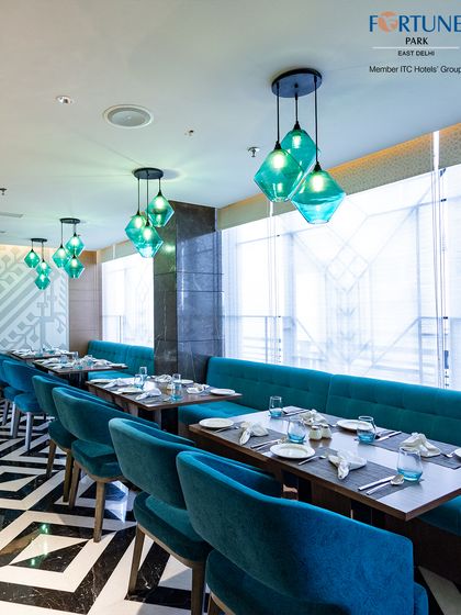 The serene and stylish ambiance of Zodiac, featuring comfortable booth seating and artistic decor that creates a relaxing environment for a meal any time of day.