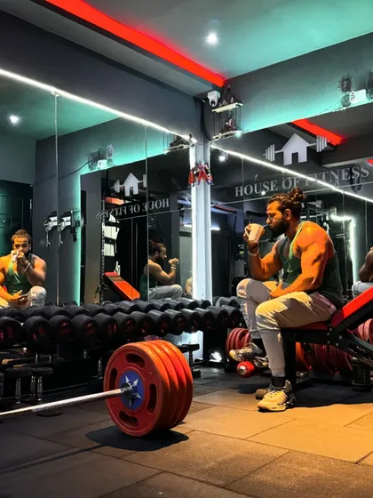 Even warriors need a break. Taking a moment with some caffeine at the House of Fitness in Bengaluru, surrounded by the tools of our trade. The calm before the next set.