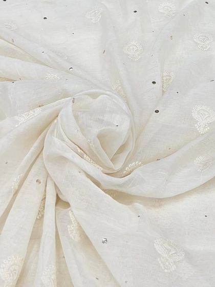 This off-white Mul Chanderi fabric is detailed with subtle buti embroidery and sequins. It’s a classic, versatile choice for a custom-fit suit, kurta, or even a lightweight saree.