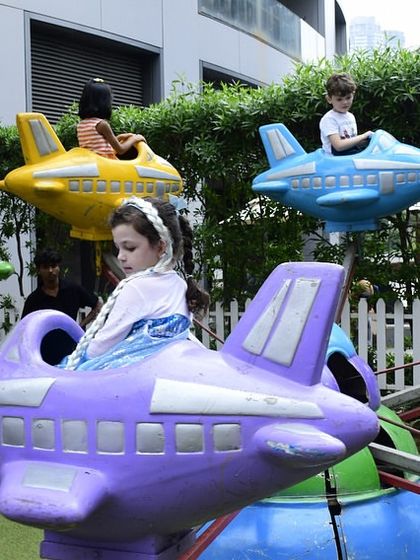 For larger outdoor spaces, I can arrange for fun rides like this mini airplane carousel, which was a huge hit at this superhero-themed party.