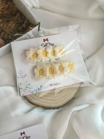 A packaged set of our daisy hair clips, ready to be gifted. They are a simple way to add a playful touch to any hairstyle.