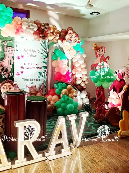A side view of the Lion King stage, showing the arrangement of props and the "AARAV" marquee letters.