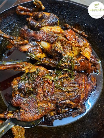 Two whole ducks simmering in a rich, dark gravy. This is how I develop the deep, complex flavors of my duck curry.