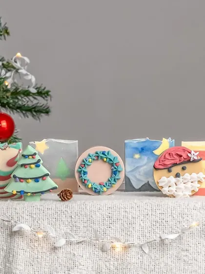 A wide shot of the entire Christmas soap collection from Wildflower Soapery. This image serves as a beautiful banner for a holiday-themed product launch.