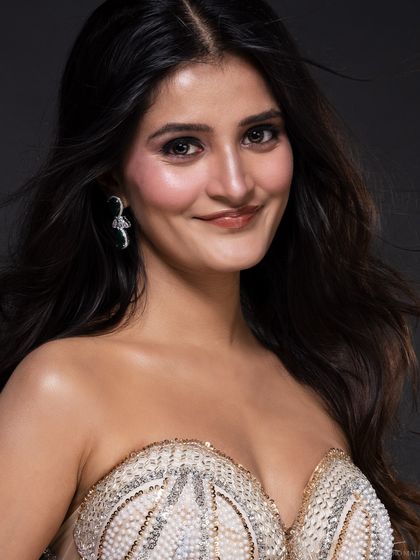 A warm, smiling portrait of the pageant contestant, capturing her personality and radiance. A good portfolio needs a mix of serious and smiling shots.