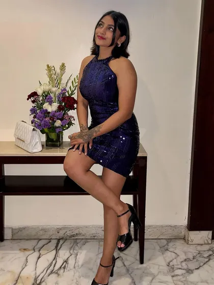 For my birthday celebration, I chose this sparkling blue sequined halter dress. It's a fun and glamorous party dress that's perfect for a special occasion.