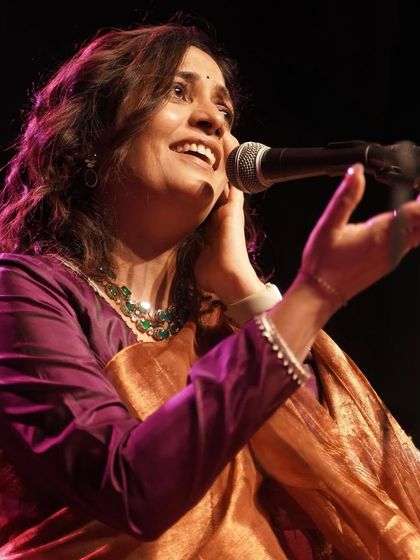 Amruta Kolatkar performing during her studio session, with the metallic saree shimmering under the lights.