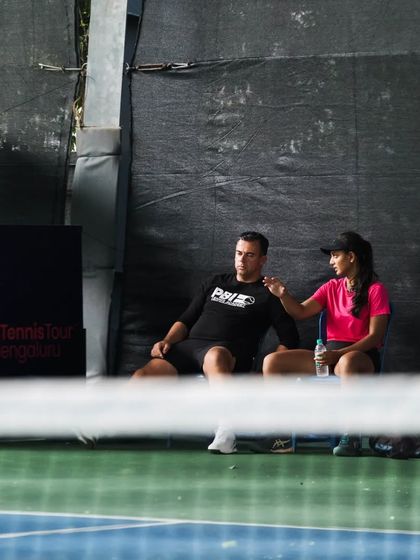 A quiet moment of coaching on the sidelines of the World Tennis Tour W25 event in Bengaluru. Our coach provides tactical advice and encouragement during a match.