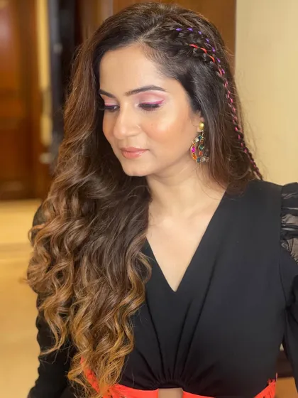 A close-up of the client's makeup and the unique braided hairstyle.