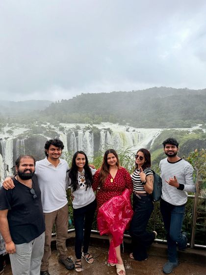 A smaller group of friends enjoying the misty view of Jog Falls.