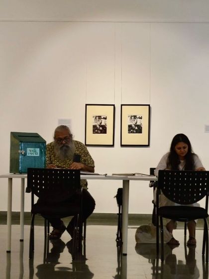 Visitors reading and discussing at the library table.