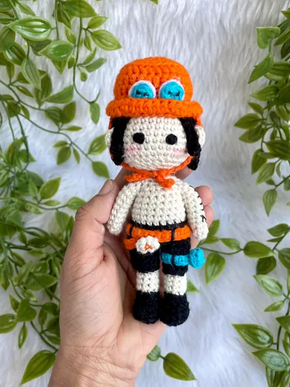 Ace from One Piece! I love creating anime characters because they are so unique and let me be creative. This doll features his signature hat, tattoos, and accessories.