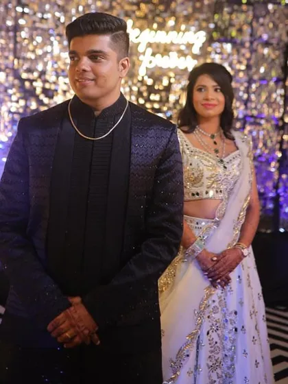 A portrait of the couple at their sangeet. The bride's makeup is soft and elegant, complementing her beautiful white and silver lehenga.