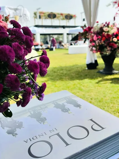 A detail shot showing a book on the history of polo in India, used as a decorative element. It's these thoughtful touches that make my events unique and personal.