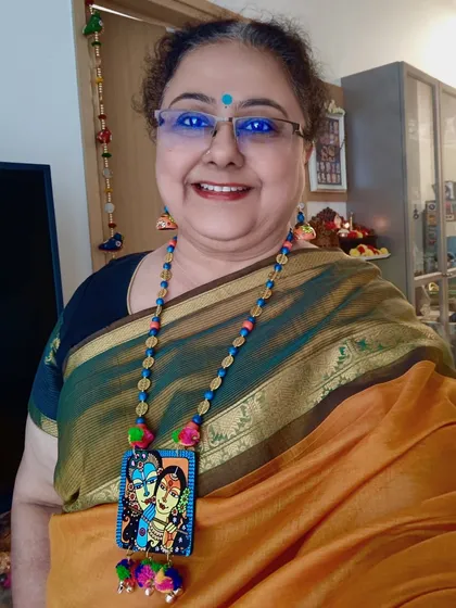 Here I am wearing my hand-painted Radha Krishna necklace set. I love seeing how my art comes to life when worn, transforming from a painting into a statement piece that complements your style. It brings me so much joy to create and wear them.