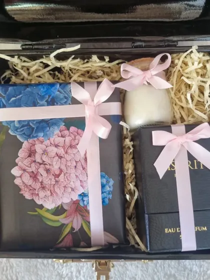 A luxurious black gift box for Mother's Day, containing perfume, a candle, and our handmade chocolates. A truly pampering gift.