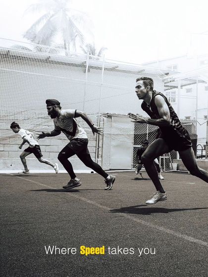 An evocative black-and-white shot of athletes exploding off the starting line. This image captures the raw power and intensity of our speed training sessions, where every drill is designed to build a more explosive first step.