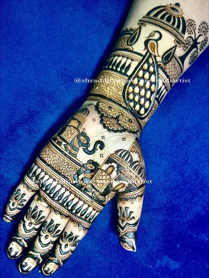This intricate design for my dear friend Amy features a baraat scene with elephants and a bride in a doli. The upper arm has a beautiful peacock near a dome, telling a complete wedding story.