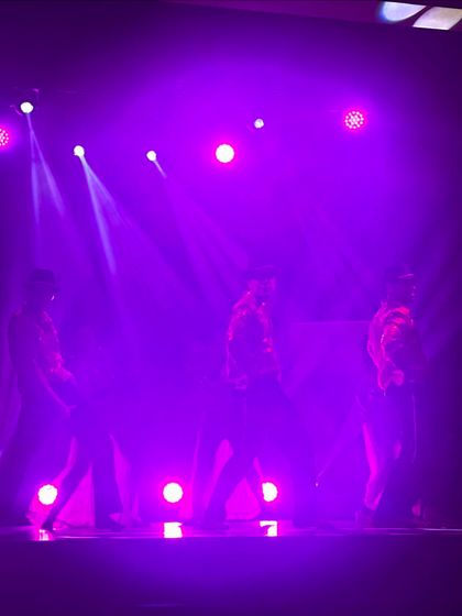 The mood and lighting of a performance can transform an event. This silhouette shot shows how we use stage lighting to create a dramatic and exciting atmosphere for a sangeet night.