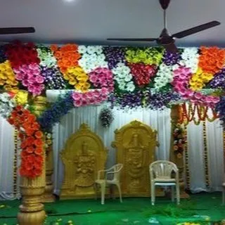 This is another example of a traditional mandap setup. The structure is heavily decorated with multi-colored flower arrangements, creating a vibrant and festive look for the wedding ceremony.