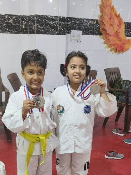 Two of our youngest competitors with their silver and bronze medals from the Inter School Championship.