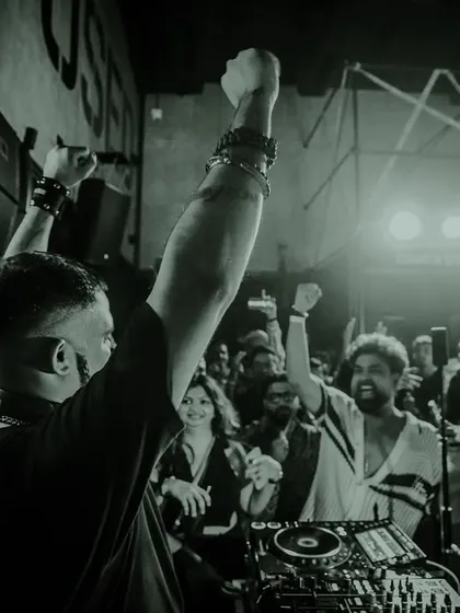 A black and white shot of me with my hands raised in triumph, connecting with the crowd. This is a moment of pure, shared energy.
