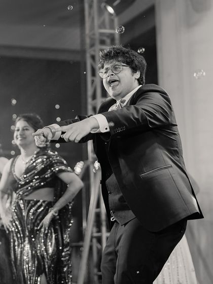 A fantastic black and white candid of the groom dancing with full energy and joy, surrounded by bubbles.