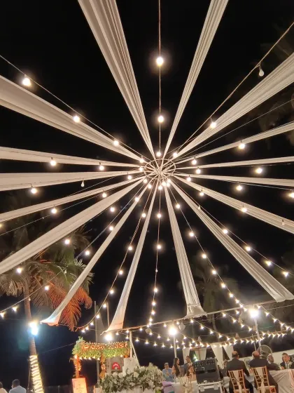 Lighting is key to setting the mood. For this large outdoor event, I designed a dramatic canopy with fabric drapes and string lights radiating from a central point, creating a stunning visual centerpiece that elevated the entire venue.