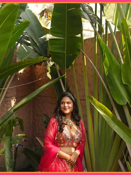 A beautiful shot of the bride amidst lush greenery, her Mehendi look a masterpiece of elegance and charm.