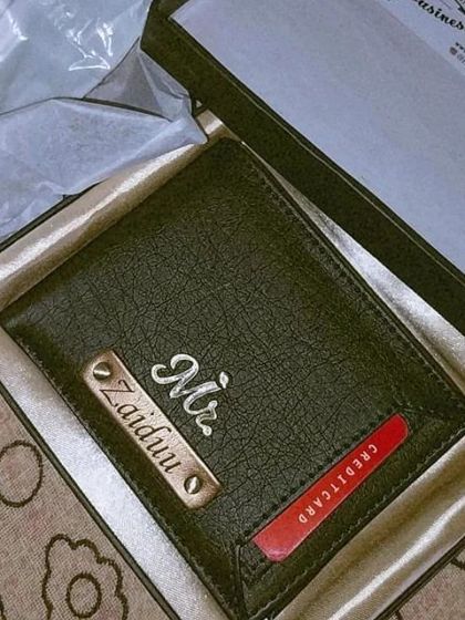 A customer's new wallet with a special credit card slot feature, personalized for 'Zaiduu'.