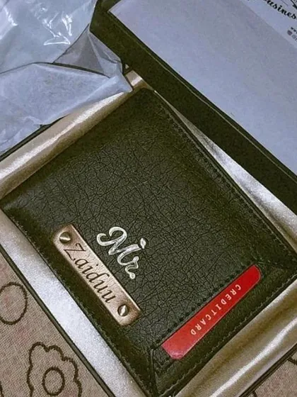 This personalized black wallet features a unique design with an external card slot in red, customized with a 'Mr.' charm and nameplate.