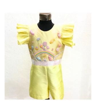 A studio shot of the Candyland Playsuit, showing the ruffled sleeves and detailed candy embroidery. It’s a unique and playful themed outfit.