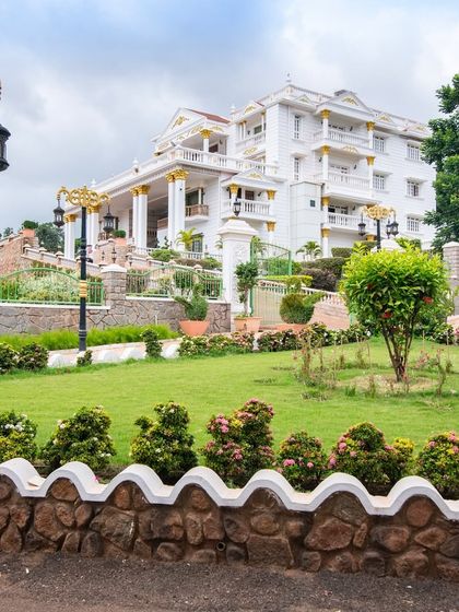 The palace viewed from its manicured lawns, showcasing the harmony between the grand structure and its surrounding landscape.