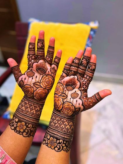 A lovely rose-themed design covering the hands. The pattern features blooming roses with detailed shading, connected by delicate vines and leaves.